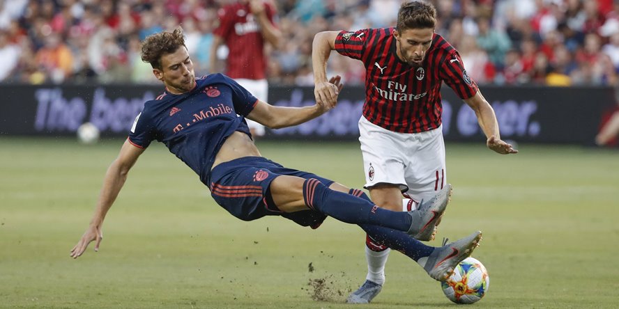 AC Milan forward Fabio Borini R is tackled by Bayern Munich midfielder Leon Goretzka L during th