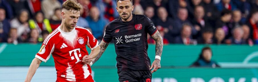 Joshua Kimmich of FC Bayern Munchen passes the ball under pressure from Aleix Garcia of Bayer 04 Leverkusen Bayer 04 Leverkusen v FC Bayern Munchen, DFB Cup Semifinal, Bayer 04 Leverkusen v FC Bayern Munchen, BayArena, April 22, 2026, Leverkusen, Germany.